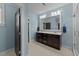 Well-lit bathroom featuring double vanity, patterned tile flooring, and modern fixtures at 508 Vervain Way, Holly Springs, NC 27540