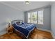 Well-lit bedroom with a large window and hardwood floors, creating a cozy and inviting space at 508 Vervain Way, Holly Springs, NC 27540