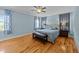 Inviting bedroom with hardwood floors, bench, and a soothing color palette, creating a restful retreat at 508 Vervain Way, Holly Springs, NC 27540