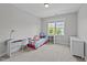 Cozy bedroom featuring a desk, white shelving and a bright window with natural light at 508 Vervain Way, Holly Springs, NC 27540