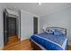 Comfortable bedroom with wood floors, with two closets and neutral wall color scheme at 508 Vervain Way, Holly Springs, NC 27540