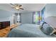 Bedroom featuring wood floors, large windows, side tables, and a soothing color palette, creating a retreat at 508 Vervain Way, Holly Springs, NC 27540