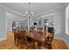 Elegant dining room featuring a large wooden table and stylish chandelier at 508 Vervain Way, Holly Springs, NC 27540