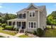 Charming two-story home with a welcoming front porch and well-maintained landscaping at 508 Vervain Way, Holly Springs, NC 27540