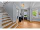 Bright foyer with hardwood floors and staircase leading to the upper level at 508 Vervain Way, Holly Springs, NC 27540