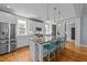 Modern kitchen with white cabinets, granite countertops, and stainless steel appliances at 508 Vervain Way, Holly Springs, NC 27540