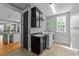 Bright laundry room featuring a sink, cabinets, and modern washer and dryer units, conveniently located at 508 Vervain Way, Holly Springs, NC 27540