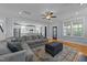 Spacious open floor plan with a comfortable sectional, connecting the living room to the modern kitchen at 508 Vervain Way, Holly Springs, NC 27540