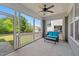 Relaxing screened porch with comfortable seating and ceiling fan, perfect for outdoor enjoyment at 508 Vervain Way, Holly Springs, NC 27540