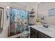 Charming bathroom featuring floral shower curtain, vanity, and decorative shelving at 51 Balboa Parkway Pkwy, Clayton, NC 27520