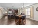 Dining area next to a kitchen featuring wood floors, a dining table, and kitchen island with barstool seating at 51 Balboa Parkway Pkwy, Clayton, NC 27520