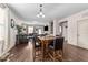 Open dining area with hardwood floors and comfortable seating adjacent to a living room with fireplace and built-ins at 51 Balboa Parkway Pkwy, Clayton, NC 27520