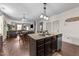 Open-concept kitchen with an island featuring a sink, dishwasher, and views into the living and dining areas at 51 Balboa Parkway Pkwy, Clayton, NC 27520