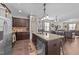 Well-equipped kitchen with dark wood cabinets, granite counters, stainless steel appliances, and an island with sink and dishwasher at 51 Balboa Parkway Pkwy, Clayton, NC 27520