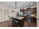 Kitchen featuring dark wood cabinets, granite countertops, stainless steel appliances, and a center island with seating at 51 Balboa Parkway Pkwy, Clayton, NC 27520