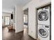 Convenient laundry area with modern, stacked washer and dryer units; bedroom in background at 51 Balboa Parkway Pkwy, Clayton, NC 27520