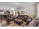 A comfy living room featuring a sectional sofa, wood flooring, and views of the open kitchen and dining area at 51 Balboa Parkway Pkwy, Clayton, NC 27520