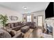 Cozy living room with a plush sectional sofa, decorative fireplace, and natural light from the nearby windows at 51 Balboa Parkway Pkwy, Clayton, NC 27520