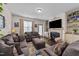 Comfortable living room with a large sectional sofa, a fireplace, built-in shelving and a large window at 51 Balboa Parkway Pkwy, Clayton, NC 27520