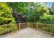 Large wooden deck surrounded by lush greenery, perfect for outdoor entertaining at 5212 Badham Pl, Raleigh, NC 27609