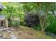 Landscaped backyard with deck, stairs, and beautiful plants for privacy at 5212 Badham Pl, Raleigh, NC 27609