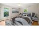 Serene bedroom with soft lighting, a ceiling fan, and three windows at 5212 Badham Pl, Raleigh, NC 27609