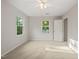Bright bedroom boasts plush carpeting, a ceiling fan, and dual windows at 5212 Badham Pl, Raleigh, NC 27609