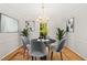 Elegant dining room with a chandelier, modern art, and a round dining table at 5212 Badham Pl, Raleigh, NC 27609