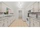 Charming kitchen with stainless steel appliances, white cabinets, and granite countertops at 5212 Badham Pl, Raleigh, NC 27609