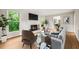 Cozy living room featuring a fireplace, lots of natural light, and modern furnishings at 5212 Badham Pl, Raleigh, NC 27609