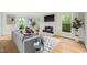 Bright living room featuring hardwood floors, fireplace and multiple windows at 5212 Badham Pl, Raleigh, NC 27609