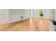A bright living room with hardwood floors, neutral paint, and a view of a front yard at 5212 Badham Pl, Raleigh, NC 27609
