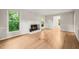 Bright living room featuring hardwood floors, fireplace and multiple windows at 5212 Badham Pl, Raleigh, NC 27609
