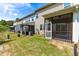 View of the back of the townhomes with private screened-in porches and tree-lined property at 525 Durants Neck Ln, Morrisville, NC 27560
