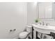 Well-lit half bathroom with a modern sink, decorative mirror, toilet, and neutral wall color at 525 Durants Neck Ln, Morrisville, NC 27560