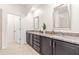 Bathroom with double sink vanity, granite countertops, dark cabinets, tile flooring, and modern fixtures at 525 Durants Neck Ln, Morrisville, NC 27560