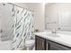 Bathroom featuring a tub and shower combination with a curtain, vanity and white tile floor at 525 Durants Neck Ln, Morrisville, NC 27560