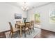 Cozy dining room with wood table, chandelier, and access to the back patio at 525 Durants Neck Ln, Morrisville, NC 27560