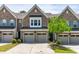 Charming brick townhome featuring an attached garage and manicured landscaping at 525 Durants Neck Ln, Morrisville, NC 27560