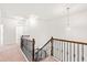 Upstairs hallway featuring carpet, recessed lighting and a wooden railing with black balusters at 525 Durants Neck Ln, Morrisville, NC 27560
