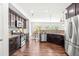Beautiful open kitchen with stainless steel appliances, granite countertops and dark wood cabinetry at 525 Durants Neck Ln, Morrisville, NC 27560