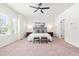 Bright main bedroom with a ceiling fan, large window, and a well-styled bed with two benches at 525 Durants Neck Ln, Morrisville, NC 27560