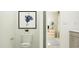 Modern bathroom featuring white fixtures, a decorative painting, and contemporary design at 545 Morning Light Dr, Angier, NC 27501