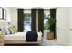 Cozy bedroom featuring a comfortable bed, bright windows, and stylish décor at 545 Morning Light Dr, Angier, NC 27501