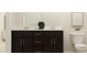 Bathroom features a double sink vanity with dark cabinets and a white countertop at 548 Morning Light Dr, Angier, NC 27501