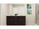 Bathroom vanity features dark cabinetry with double sinks, framed with a large mirror at 548 Morning Light Dr, Angier, NC 27501