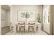 Elegant dining room featuring a white table with seating for six and a stylish area rug at 548 Morning Light Dr, Angier, NC 27501