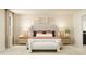 Modern main bedroom featuring soft neutral tones, bench seating, art, and decorative lamps at 548 Morning Light Dr, Angier, NC 27501