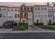 Charming brick townhome with attached garage and manicured front lawn at sunset at 5504 Crabtree Park Ct, Raleigh, NC 27612