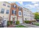 Charming brick townhome featuring a one car garage and well maintained front landscaping at 5504 Crabtree Park Ct, Raleigh, NC 27612